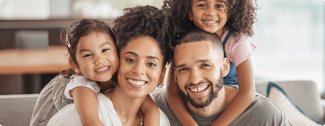 family sitting on couch with children