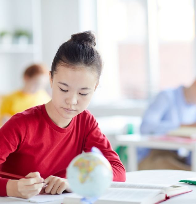 teenager working on an assignment in class